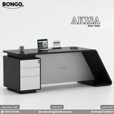 A promotional image of a modern executive desk, branded "AKISA Boss Table". The desk has a black top and a sleek, contemporary design. One side is supported by a solid, curved black leg, while the other rests on a black pedestal with three white drawers. On the desktop, there is an open laptop, a mug, and a small notebook. The "BONGO" logo is displayed in the top-left corner and on a small sign on the desk.