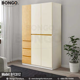 A white Butterfly Cupboard with Water Resistant Strong Laminated Board elements, featuring a closed door and multiple drawers, placed in a room with a potted plant to the side.