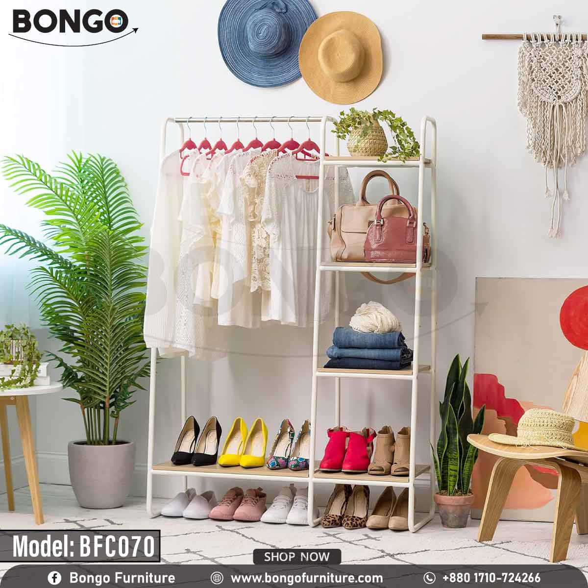 An industrial-style open garment rack from BONGO, featuring a black metal frame and dark wood-grain shelves. The unit has a wide section with a hanging rod on the right and a narrow five-tier shelving tower on the left. The rack is shown in a bedroom, fully stocked with clothes, shoes, and a scarf.