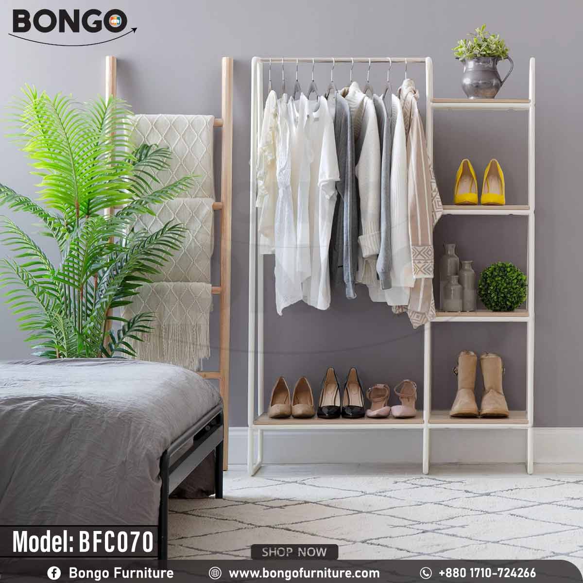 An industrial-style open garment rack from BONGO, featuring a black metal frame and dark wood-grain shelves. The unit has a wide section with a hanging rod on the right and a narrow five-tier shelving tower on the left. The rack is shown in a bedroom, fully stocked with clothes, shoes, and a scarf.