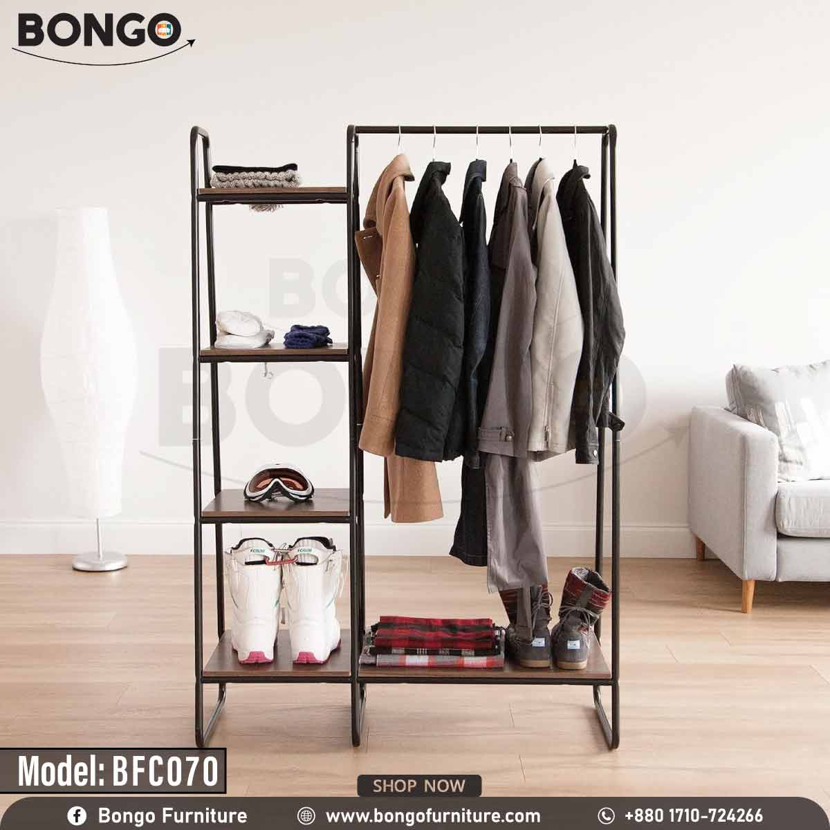 An industrial-style open garment rack from BONGO, featuring a black metal frame and dark wood-grain shelves. The unit has a wide section with a hanging rod on the right and a narrow four-tier shelving tower on the left. The rack is shown in a room setting, fully stocked with winter jackets, ski boots, and goggles.