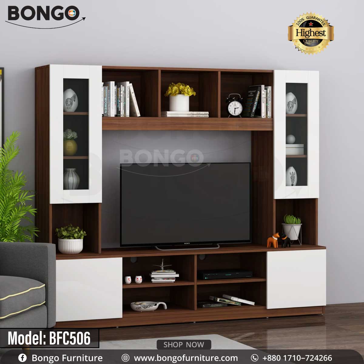 A brown and white monitor TV shelf with glass doors and various decorative items, a TV is placed on the shelf with a plant and books around it.