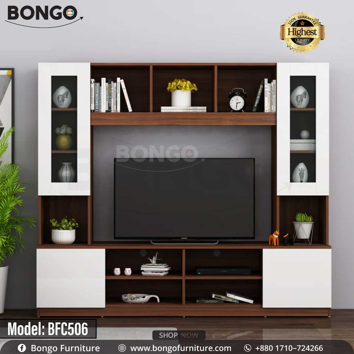 A brown and white monitor TV shelf with glass doors and various decorative items, a TV is placed on the shelf with a plant and books around it.