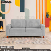 A Ash upholstered sofa with wooden legs, positioned in a room with colorful wall art and decor.