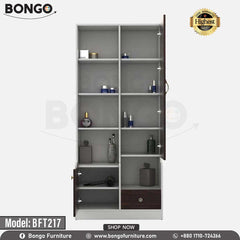 A white and brown Maven Dressing Table with a mirror, model BFT217, displayed in a room with various clothes and accessories arranged around it. A white and brown Maven Dressing Table with a mirror, model BFT217, displayed in a room with various clothes and accessories arranged around it.