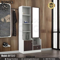 A white and brown Maven Dressing Table with a mirror, model BFT217, displayed in a room with various clothes and accessories arranged around it. A white and brown Maven Dressing Table with a mirror, model BFT217, displayed in a room with various clothes and accessories arranged around it.