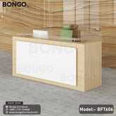 A modern reception desk from BONGO with a light wood-grain frame. The front of the desk features a large, white inset panel, and a raised glass shelf serves as the transaction counter. The desk is shown in a modern lobby setting.