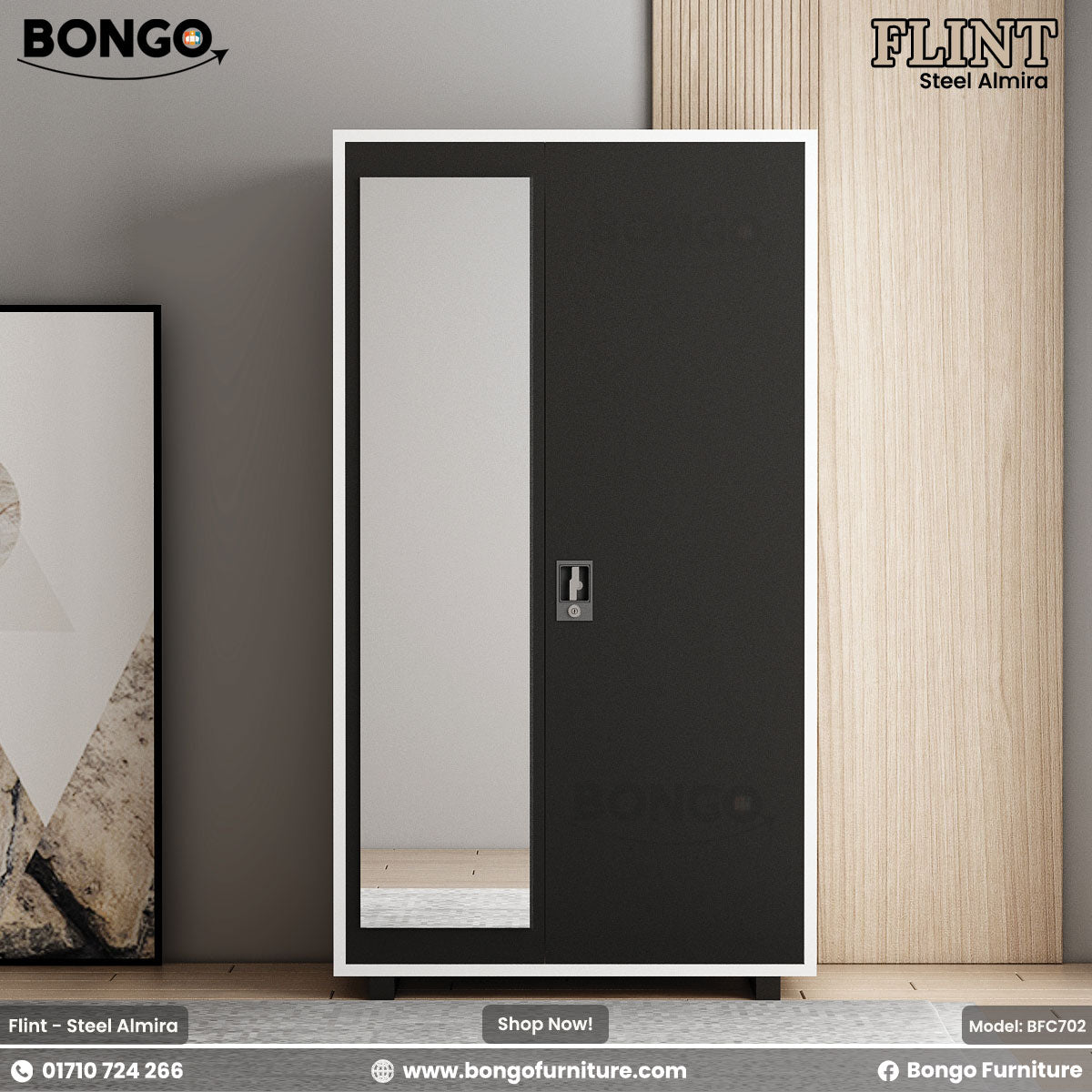 A black steel almirah with a mirror door, positioned against a wall with a painting to the left, on a wooden floor.