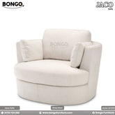 A beige Jaco sofa with a plush design, featuring Shanell fabric upholstery and a matching round footstool.