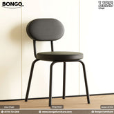 Black chair with cushioned seat and backrest on a light wooden floor and beige wall background, featuring Bongo Furniture branding.