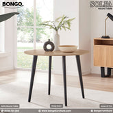 A round dining table with black legs and a beige laminated board top, branded by Bongo Furniture, with a vase and bowl placed on top.