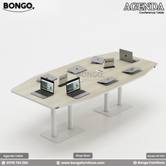 A conference room setting featuring the Agenda Conference Table with a dark Water Resistant Strong Laminated Board finish, accompanied by black office chairs and laptops on the table.