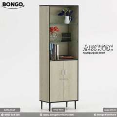 A product image of the "ARCTIC Multipurpose Shelf," a tall, narrow storage tower. The unit features a light wood grain finish with a contrasting dark trim and stands on four slim, black legs. The bottom half is a two-door cabinet with silver handles, while the top half consists of three open, glass display shelves. The shelves are styled with books and small vases of flowers. The "BONGO" brand logo is in the top-left corner.