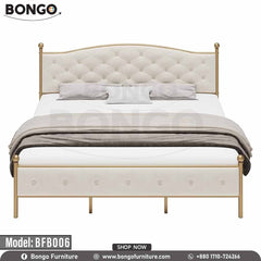 A queen-sized metal bed with a white headboard and footboard, model BFB006, in a room with decor.