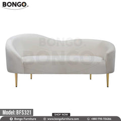 A modern Victoria sofa with a white upholstery, model BFS321, with gold steel legs, placed in a bright room with a window and a potted plant in the background.