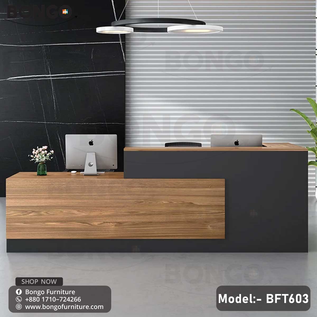 A contemporary office desk with a wood finish and black detailing, equipped with a computer monitor and keyboard, set against a modern office background.
