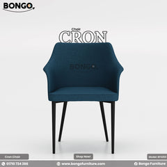 A promotional image of the 'Chair CRON' from BONGO. This is a modern dining chair upholstered in a textured, deep blue fabric, featuring flared arms that are integrated with the backrest. The chair stands on four slender, angled black legs.