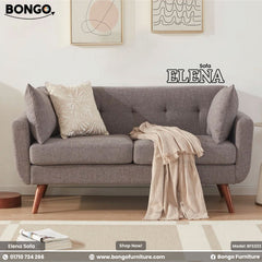 Gray sofa with decorative pillows and a blanket in a living room setting, featuring the Bongo Furniture brand.