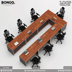 A modular conference table named Loop with a brown tabletop, Back legs, and multiple chairs around it.