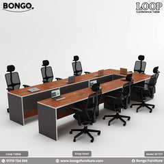 A promotional image of the 'LOOP Conference Table' from BONGO. The large conference table is arranged in a U-shape and features a reddish-brown wood-grain top with a solid black base. Ten modern, high-back ergonomic office chairs are arranged around the table, which is staged with several laptops.
