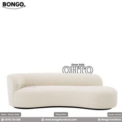 A white divan sofa with a minimalistic design, featuring a low back and a sleek, modern aesthetic.