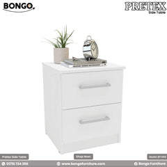A modern white two-drawer nightstand shown in a bedroom setting. The simple, rectangular bedside table has two drawers with silver bar pulls and is decorated on top with a plant, books, and a classic silver alarm clock.