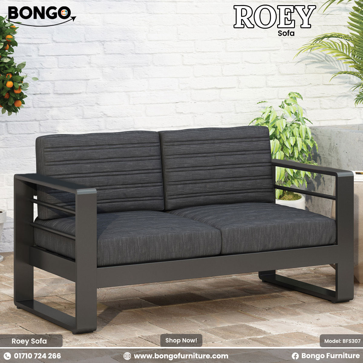 Gray sofa with black frame on a patio with plants and a white brick wall.