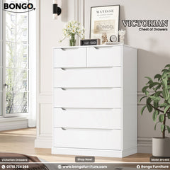 A promotional image of the "VICTORIAN Chest of Drawers." The tall, modern dresser is solid white and features six handleless drawers. The top row has two smaller drawers side-by-side, followed by four full-width drawers below. The top of the chest is decorated with a vase of white flowers, a small clock, and other decorative figurines. The "BONGO" brand logo is in the top-left corner.