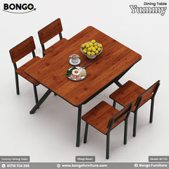 A Yummy dining table set with four Granada Pine and Granada Pine chairs, and Black Edge.